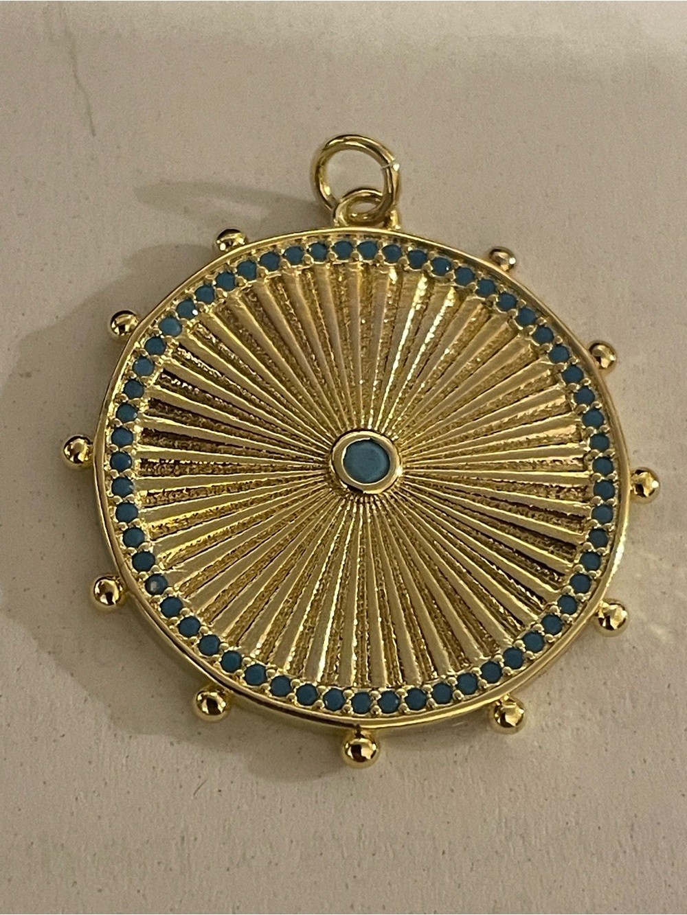 Gold-Tone Sunburst Pendant with Blue Accents